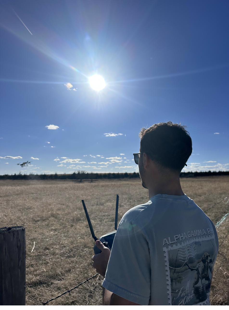 Operator running spray drone in a field